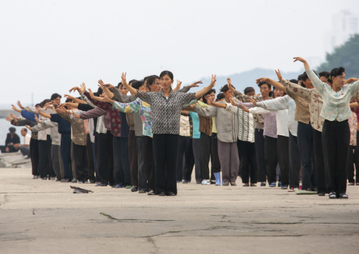 Women raising hands during morning exercise session, Kangwon Province, Wonsan, North Korea