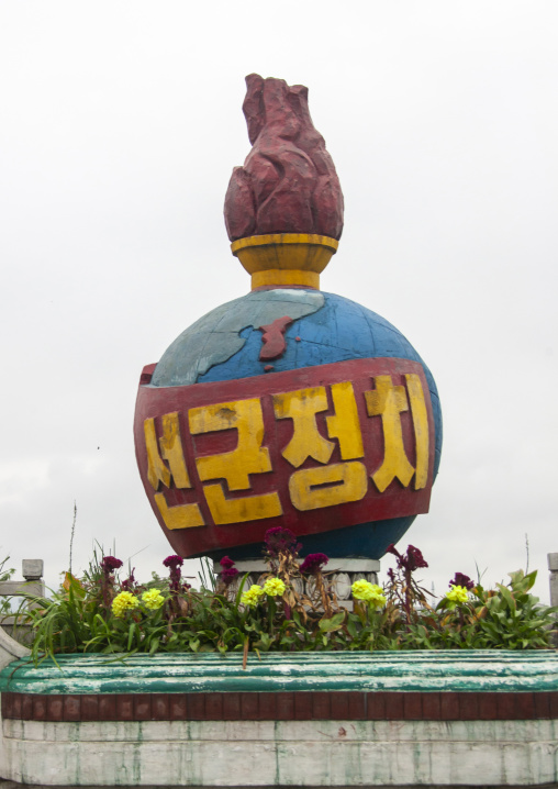 Flame on a globe with Songun slogan, South Hamgyong, Hamhung, North Korea