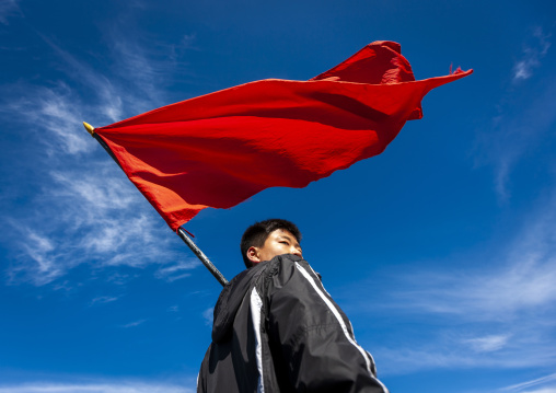 North Korean student with red flag in mount Paektu, Ryanggang, Mount Paektu, North Korea