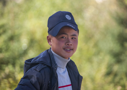 Portrait of a young North Korean man wearing a Puma cap, Ryanggang, Samjiyon, North Korea
