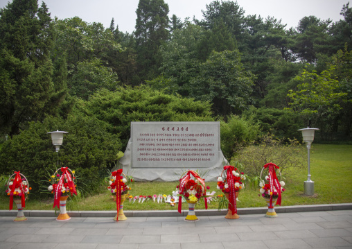 Baskets of flowers in front of a stele dedicated to the Dear Leaders, DGC, Pyongyang, North Korea