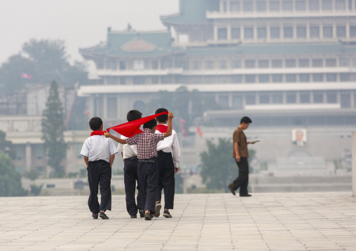 Rear view of North Korean pioneers boys in the street, DGC, Pyongyang, North Korea