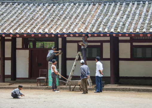 North Korean workers repairing a roof in a museum, North Hwanghae, Kaesong, North Korea