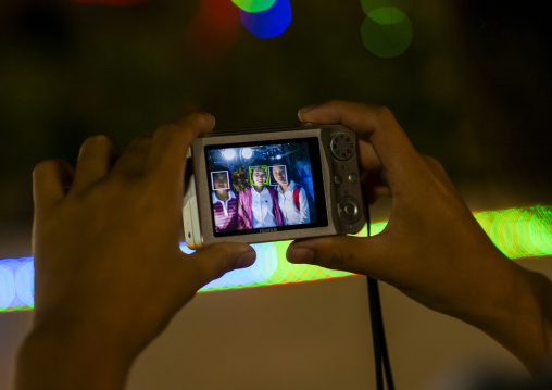 North Korean teenage girl taking pictures of her friends, DGC, Pyongyang, North Korea