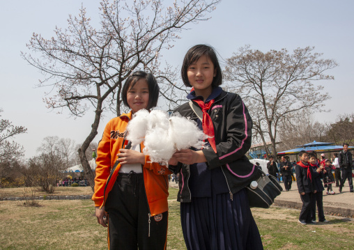 Young pioneers girls with candyfloss in a park, DGC, Pyongyang, North Korea