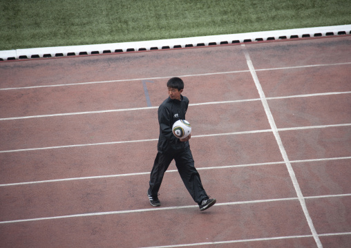 Man with a ball in Kim il Sung stadium during a football game, DGC, Pyongyang, North Korea