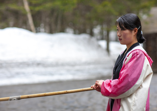 Woman removing snow in the former secret camp of the Korean resistance, Ryanggang, Samjiyon, North Korea