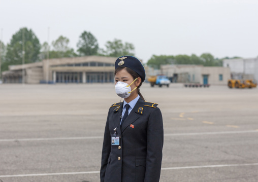 North Korean woman wearing a face mask in Sunan international airport, DGC, Pyongyang, North Korea