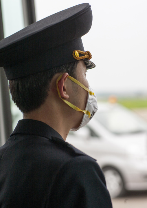 North Korean man wearing a face mask in Sunan international airport, DGC, Pyongyang, North Korea
