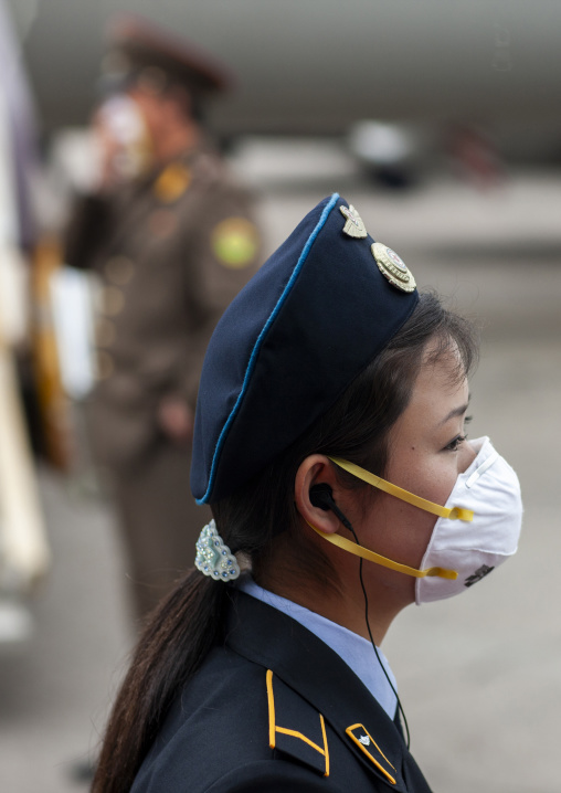 North Korean woman wearing a face mask in Sunan international airport, DGC, Pyongyang, North Korea