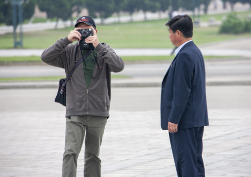 North korean guide with a western tourist taking pictures, DGC, Pyongyang, North Korea