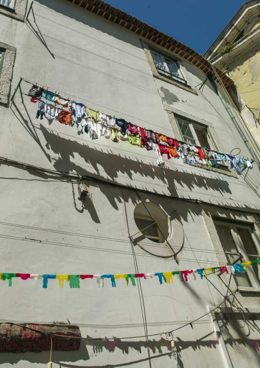 Clothes hanging outside house drying to the sun, Lisbon district, Lisbon, Portugal