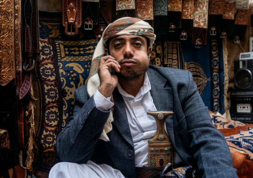 Man with a mobile phone chewing khat, Amanat Al-Asemah,  Sanaa, Yemen