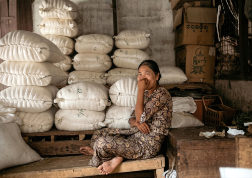 Women sit in front of bags in a market, Rakhine State, Ngapali, Myanmar