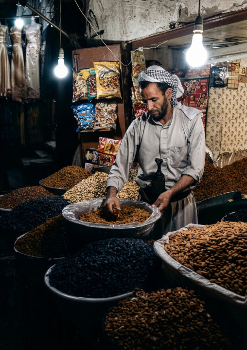Yemeni man selling almonds in the souk, Amanat Al-Asemah, Sanaa, Yemen
