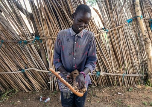Mundari boy playing local chordophone, Central Equatoria, Terekeka, South Sudan