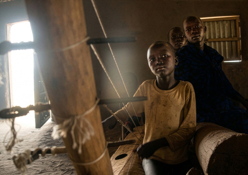 Mundari boy playing local chordophone, Central Equatoria, Terekeka, South Sudan