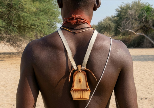 Himba tribe man with a wooden kalimba on his back, Cunene Province, Oncocua, Angola