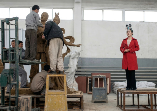 Artists working on a bronze statue at Mansudae art studio, DGC, Pyongyang, North Korea