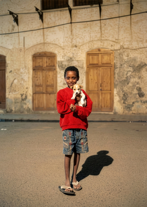 Eritrean boy with his dog in his arms, Northern Red Sea, Massawa, Eritrea