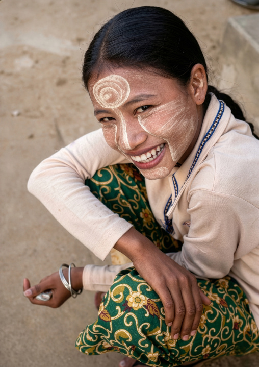 Portrait of a burmese girl with thanaka selling coconuts, Rakhine State, Ngapali, Myanmar