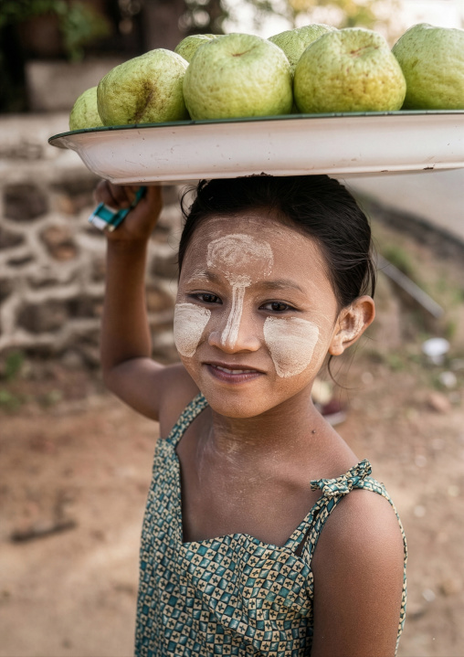 Portrait of a burmese girl with thanaka selling coconuts, Rakhine State, Ngapali, Myanmar