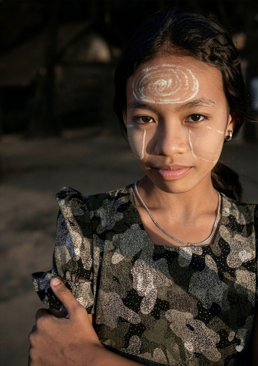 Portrait of a burmese girl with thanaka selling coconuts, Rakhine State, Ngapali, Myanmar