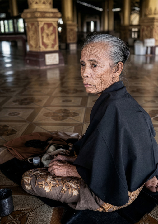 Old burmese woman in a temple, Yangon region, Yangon, Myanmar