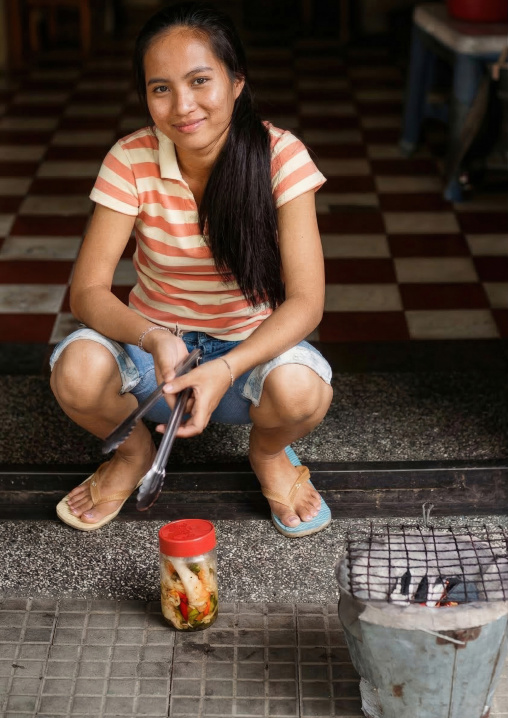 Young cambodian woman selling bbq food in the street, Phnom Penh province, Phnom Penh, Cambodia