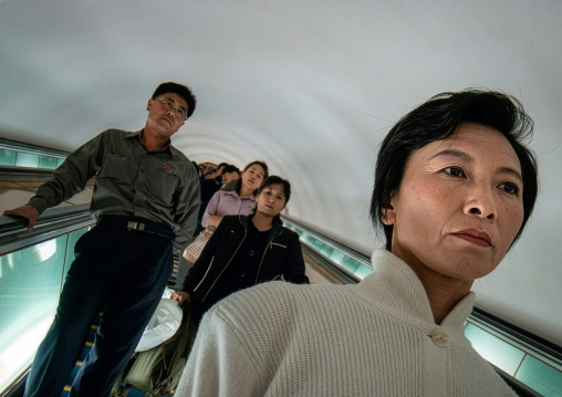 North Korean people using escalator leading to the subway station, DGC, Pyongyang, North Korea