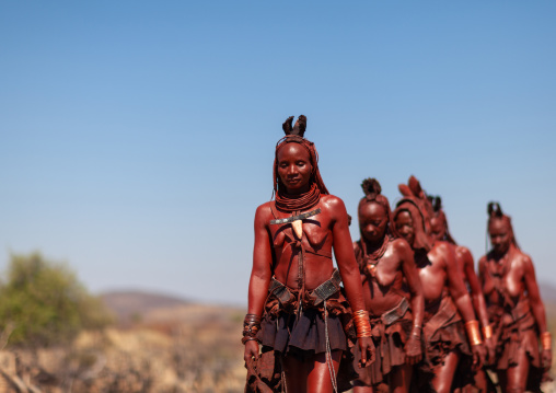 Himba tribe women walking in line, Cunene Province, Oncocua, Angola