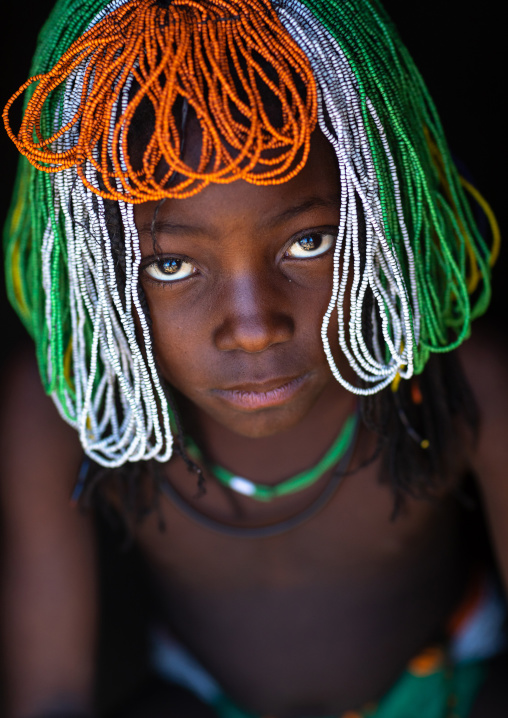 Muhakaona tribe girl with a beaded wig used for the fico ceremony, Cunene Province, Oncocua, Angola