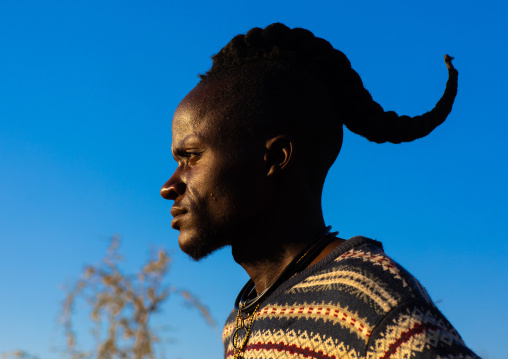 Himba tribe man with a special hairstyle which shows he is single, Cunene Province, Oncocua, Angola