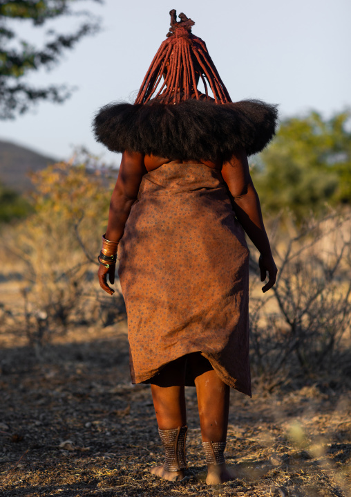 Himba tribe woman wearing a cow skin against the cold, Cunene Province, Oncocua, Angola