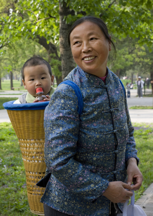 Grandmother With A Baby In A Basket On Her Back, Beijing China