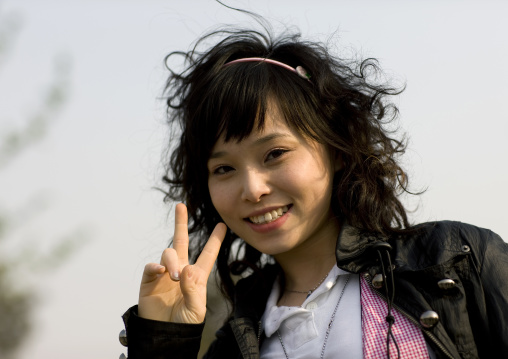 Cute Teenager Making V Sign To The Camera, Beijing, China
