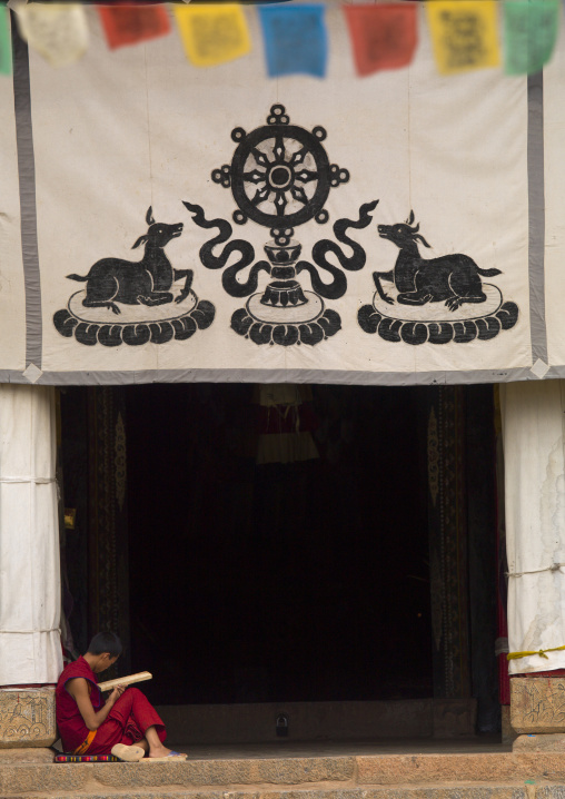 Novice Reading In Front Of Zhamei Lamaism Monastery, Yongning, Yunnan Province, China