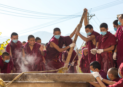 Monks preparing the painting of a temple in Rongwo monastery, Tongren County, Longwu, China