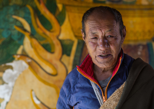 Tibetan pilgrim man in Rongwo monastery, Tongren County, Longwu, China
