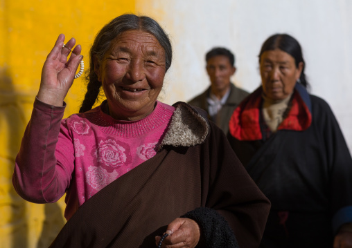 Pilgrim tibetan pilgrims walking the kora around Rongwo monastery, Tongren County, Longwu, China