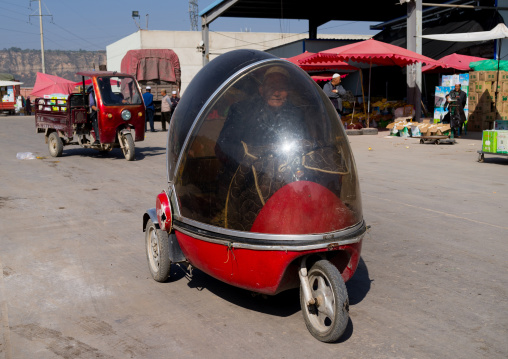 Cute small three-wheeled chinese retro car in the street, Gansu province, Linxia, China