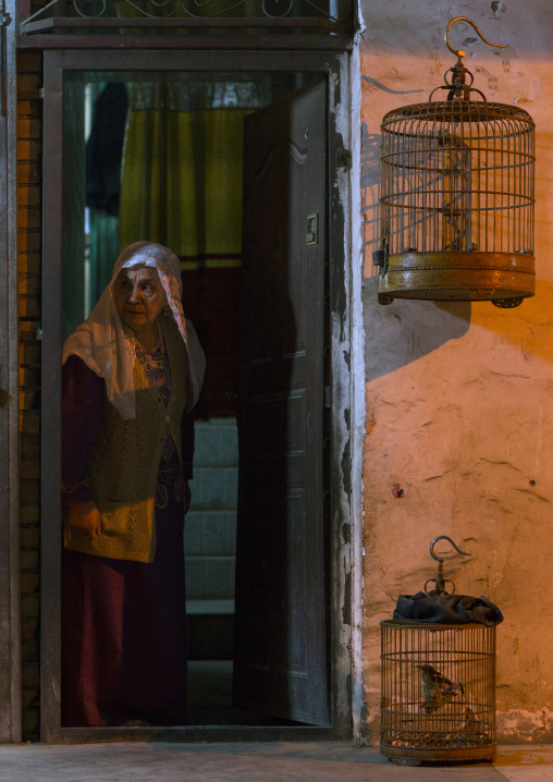 Old Uyghur Woman and bird cages, Kashgar, Xinjiang Uyghur Autonomous Region, China