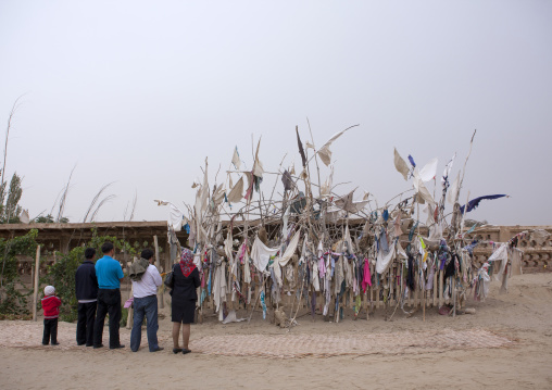 Family Praying At Imam Asim Tomb In The Taklamakan Desert, Xinjiang Uyghur Autonomous Region, China