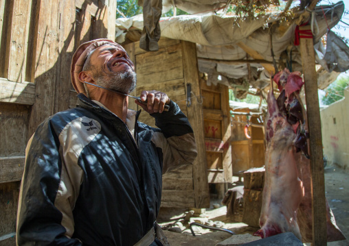 Butcher joking with a knife in the market, Badakhshan province, Ishkashim, Afghanistan