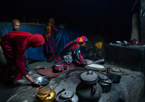 Afghan woman making bread inside her traditional pamiri house, Badakhshan province, Khandood, Afghanistan