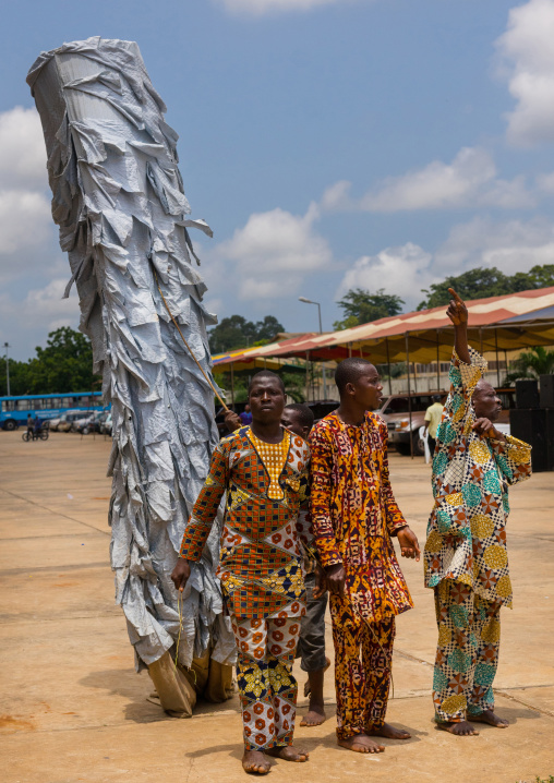 Benin, West Africa, Porto-Novo, men guiding a zangbeto guardian of the night spirit