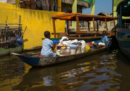 Benin, West Africa, Ganvié, boat passing in front of the stilt village on lake nokoue