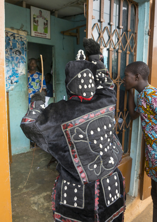 Benin, West Africa, Porto-Novo, egoun egoun spirit of the deads walking in the street with his guide to ask money to people