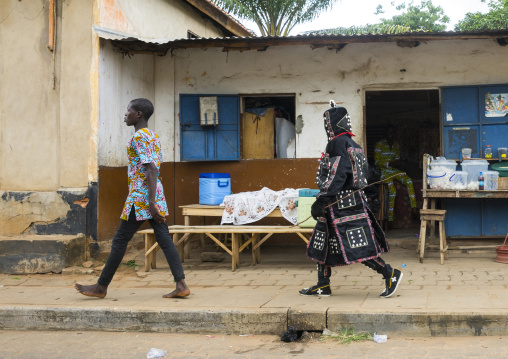 Benin, West Africa, Porto-Novo, egoun egoun spirit of the deads walking in the street with his guide to ask money to people