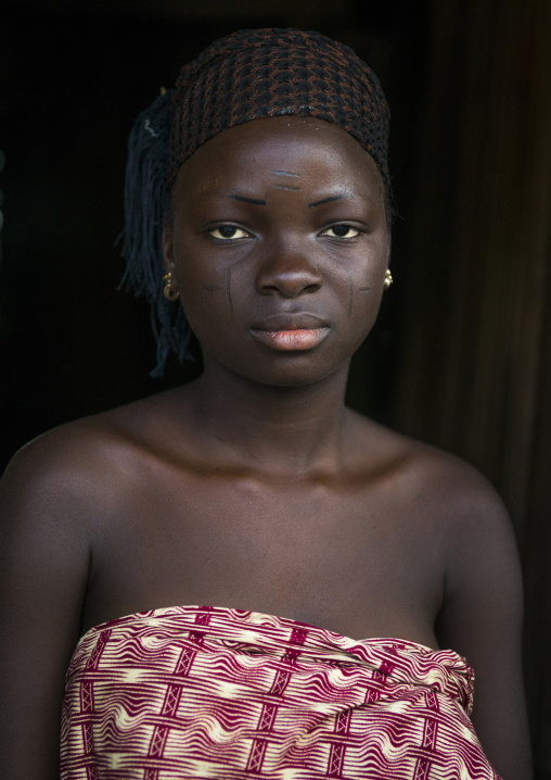 Benin, West Africa, Onigbolo Isaba, holi tribe woman covered with traditional facial tattoos and scars portrait